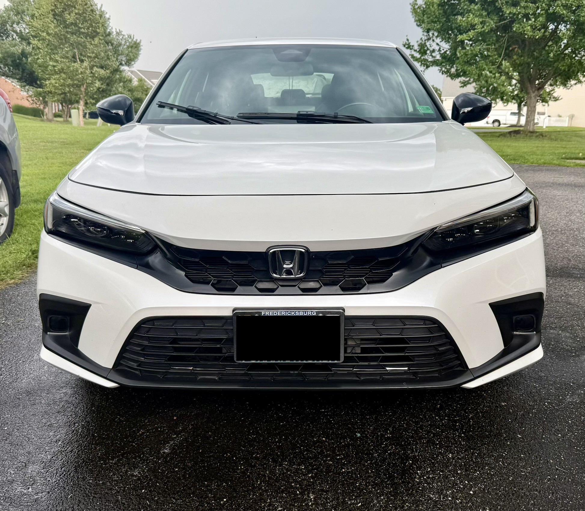 Front end of a white Honda Civic after paint decontamination